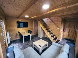 a living room with a couch and a staircase at TEVA Lipno 131 in Lipno nad Vltavou