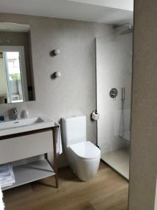 a bathroom with a white toilet and a sink at Hotel Las Rocas de Isla in Isla +44 photos