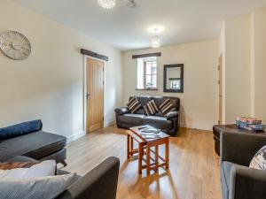 a living room with a couch and a table at Herdwick House - Uk42805 in Mungrisdale
