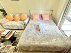 a bedroom with a bed and a couch at Condo Unit inside IT Park Lahug Cebu City in Cebu City