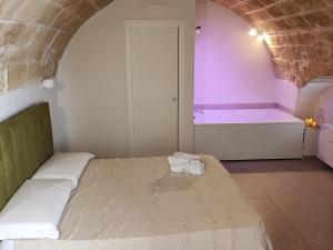 a bedroom with a bed and a bath tub at Suite SaChi in Modugno