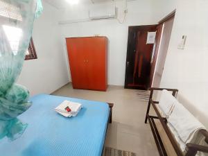 a room with a blue bed and a red door at Breeze Blows- Solitude Holiday Home in Matara
