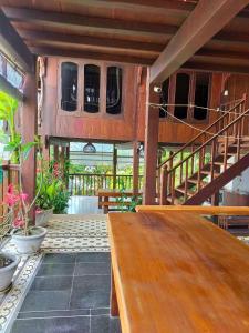 a wooden bench in a room with a staircase at Cham Island Wooden Cabin in Hoi An