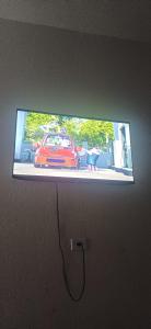 Un televisor de pantalla plana con un coche encima. en Casa Faculdade and Regional Cruzeiro, en Cachoeira Paulista