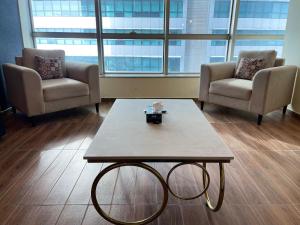 a waiting room with two chairs and a coffee table at Centaurus Ultra Luxury 2BHK Mountain Vista Apartment in Islamabad