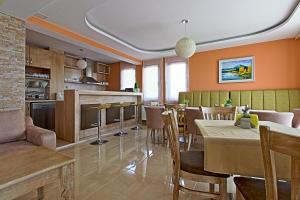 a kitchen and dining room with a table and chairs at White House in Ognyanovo