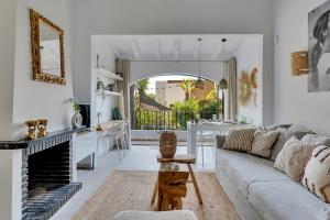 a living room with a couch and a fireplace at Bungalow Marquérite Moraira, 5 minutes from beach in Teulada