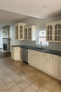 a kitchen with white cabinets and a sink at E&S Lake House Retreate & S Lake House Retreat in Amherstburg