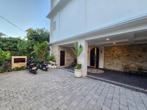 a building with motorcycles parked outside of it at The Polle Canggu in Badung
