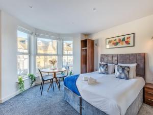 a bedroom with a large bed and a table at Sand Dune - Uk48699 in Lancaster