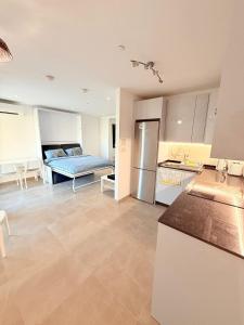 a kitchen and living room with a bed in the background at E1 Simple Apartment in Gibraltar
