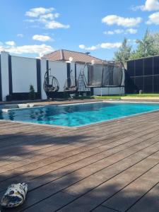 a house with a swimming pool with a shoe next to it at Casa Italiana with Exclusive Pool in Odesa