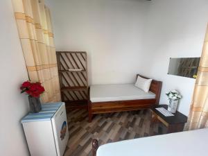 a small room with a couch and a refrigerator at Vyogo Blue Villa Jambiani in Mfumbwi