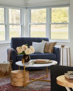 WaupoosにあるGran Roble - Charming Countryside Retreatの青いソファとテーブルのあるリビングルーム