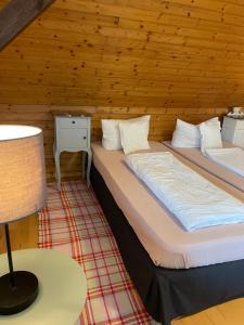 a bedroom with two beds in a wooden cabin at Malermeisterhaus in Stühlingen +56 photos