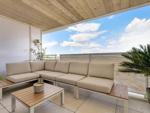 a living room with a couch on a balcony at Nouveau T3 Mira Lattes Proche Montpellier et Plages in Lattes