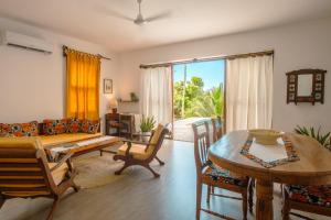a living room with a couch and a table at Matemwe House 2 in Matemwe