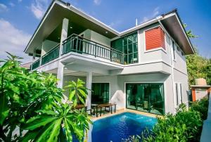a house with a swimming pool in front of it at Baan Viset Pool Villa Krabi in Ao Nang Beach