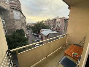a balcony with a table and a view of a street at Family Comfort Apartment on Mashtots 3 in Aghk'ilisa