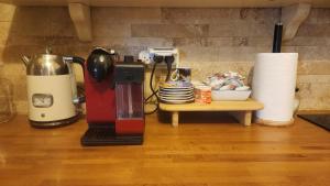 a coffee maker sitting on a counter next to a table at מול השדות-בית עם סוויטה וממ"ד in Temarah