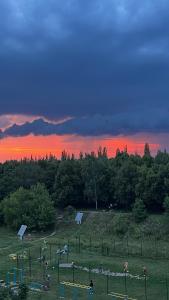 a group of people playing in a field at sunset at 1кімнатна VIP Ковпака Сумської Тероборони in Sumy +4 photos