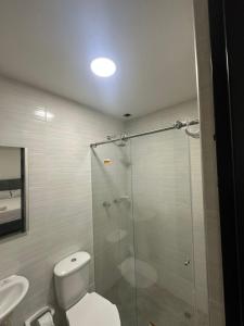 a bathroom with a shower and a toilet and a sink at Hotel vizion in Ibagué +10 photos