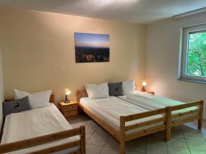 two beds in a room with two lamps and a window at Ferienhaus in Elend in Elend +20 photos