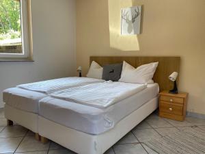 a bedroom with a large white bed and a window at Ferienhaus in Elend in Elend