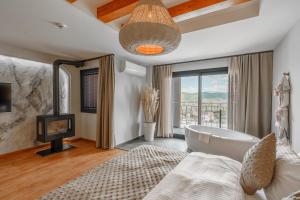 a bathroom with a tub and a tv and a bed at Ephesus Select Suites in Kuşadası +33 photos