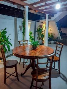a wooden table and chairs in a room with potted plants at Mirissa Villa Green Pepper in Mirissa +93 photos