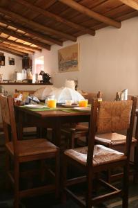 a dining room table and chairs with orange juice on it at Monte do Vale in Vila Boim