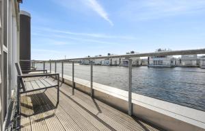 a bench sitting on a balcony overlooking the water at Seebär in Olpenitz
