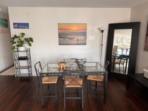 a glass table and chairs in a living room at Boho Sunsets Convention Center in San Diego
