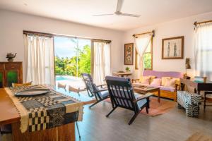 a living room with a table and chairs at Matemwe House 1 in Matemwe