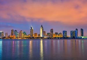a view of a city from the water at night at Boho Sunsets Convention Center in San Diego