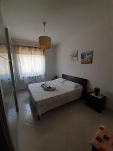 a bedroom with a bed and a window at Nice Home Pizzo in Pizzo