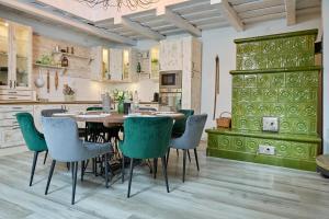 a dining room with a table and chairs in a kitchen at Csend,Élet,Regéc in Regéc