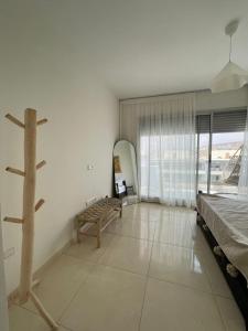 a room with a bed and a tree in it at Beach & Pool - Adan Beach in Aourir +29 photos