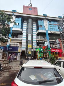 a white car parked in front of a building at hotel anjani inn in Ahmedabad