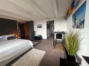 a bedroom with a bed and a desk and a table at Himalayan vibes in Icogne