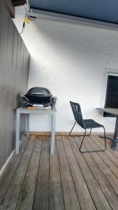 a chair sitting next to a table in a room at Stadtappartement Saalfelden in Saalfelden am Steinernen Meer