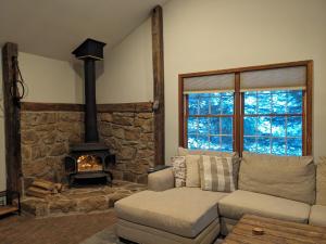 a living room with a couch and a fireplace at Hidden River Lodge at Hawk Mountain  +44 photos