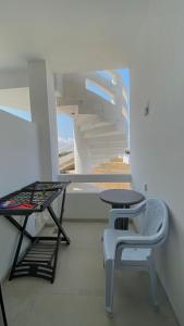 a room with a table and a table and a chair at Dar Lebharr Kélibia in Kelibia