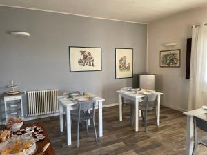a dining room with three tables and chairs at B&B Vignicella in Castelbuono