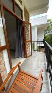 a porch with a wooden bench on a balcony at AHU hiriketiya in Hiriketiya +76 photos