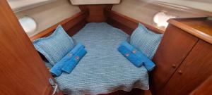 a seat in a boat with blue pillows at Velero Passionetenerife in San Miguel de Abona