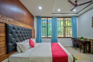 Un dormitorio con una cama grande y un escritorio. en Hotel pine house, en Calangute