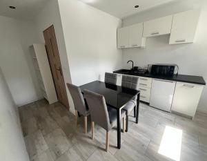 a kitchen with a dining room table and chairs at Domek w Rytrze in Rytro