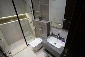 a bathroom with a toilet and a sink and a shower at 3BR next to stars avenue in Jeddah