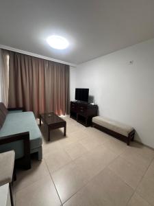 a living room with a bed and a couch and a television at Villa Tanita in Ravda +22 photos